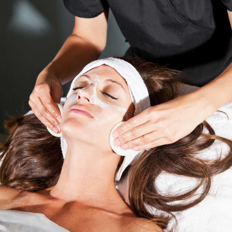 Female receiving a facial while lying down with her eyes closed